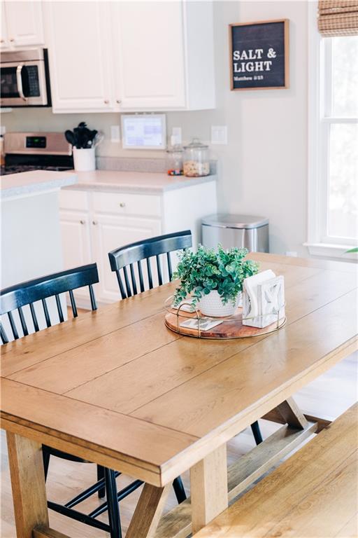 2533 Gold Hill Court Villa Rica, GA 30180 - Photo 14 of 50 a view of kitchen island with stainless steel appliances stove refrigerator and dining table
