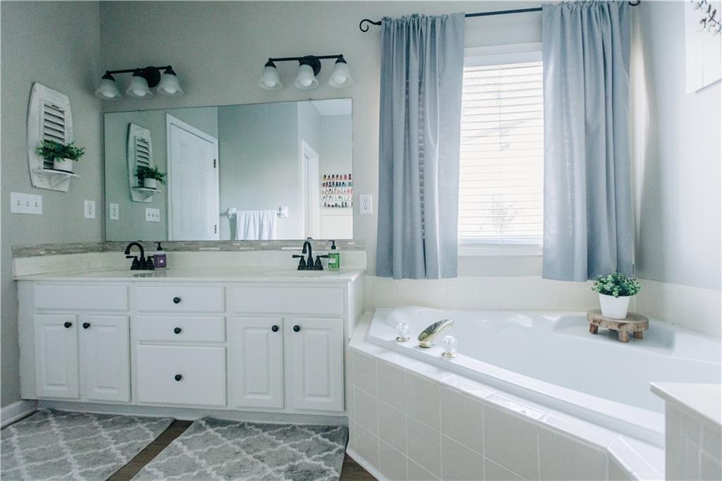 2533 Gold Hill Court Villa Rica, GA 30180 - Photo 26 of 50 a bathroom with a bathtub sink and mirror