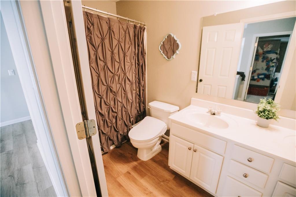 2533 Gold Hill Court Villa Rica, GA 30180 - Photo 33 of 50 a bathroom with a sink a toilet and shower curtain