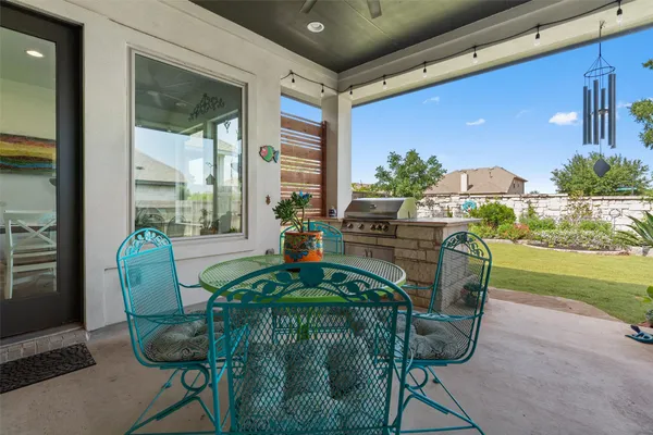 a dining room with furniture and a floor to ceiling window