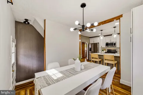 a spacious bedroom with a bed and wooden floor