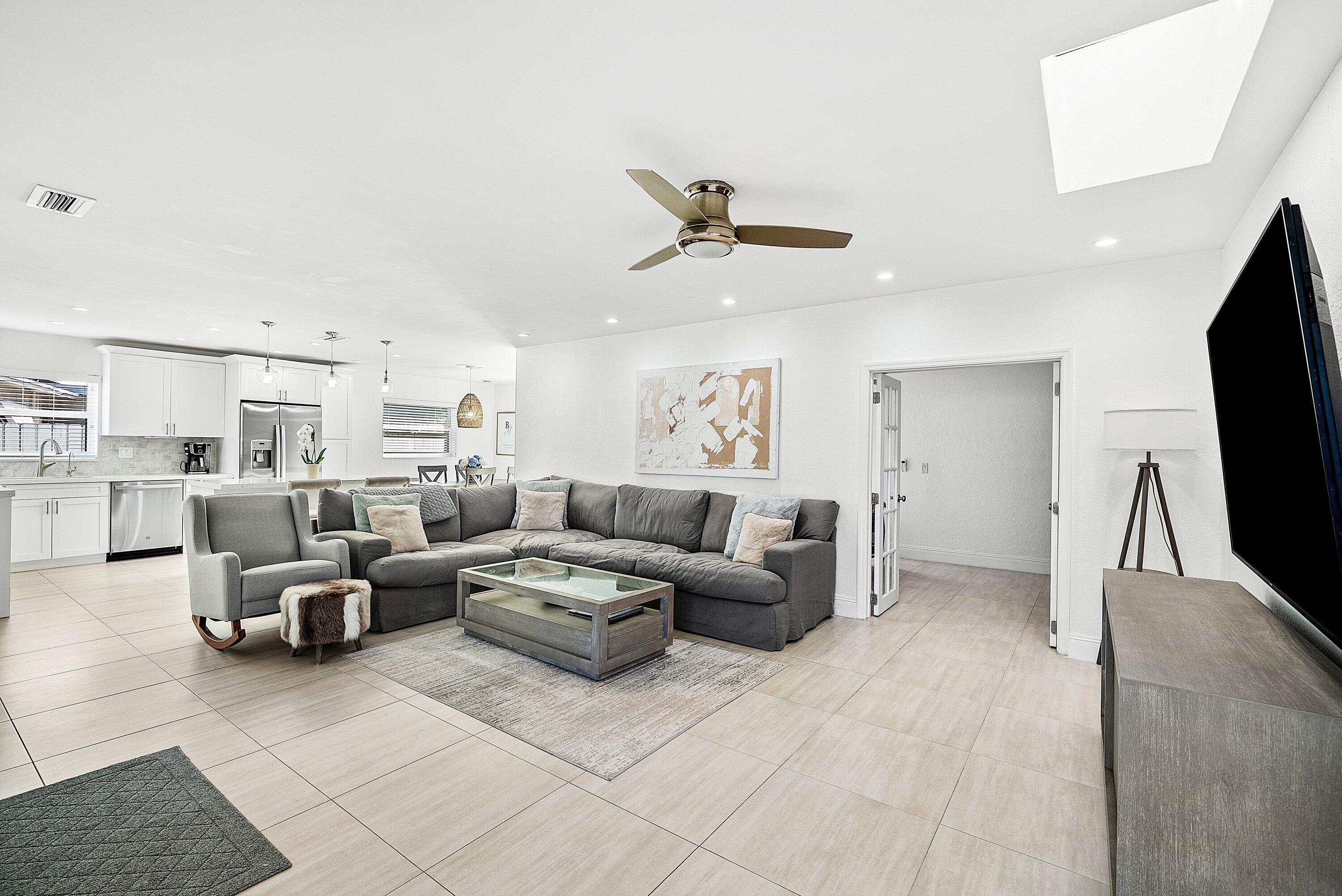 124 Oregon Lane Boca Raton, FL 33487 - Photo 14 of 41 a living room with couches and a flat screen tv