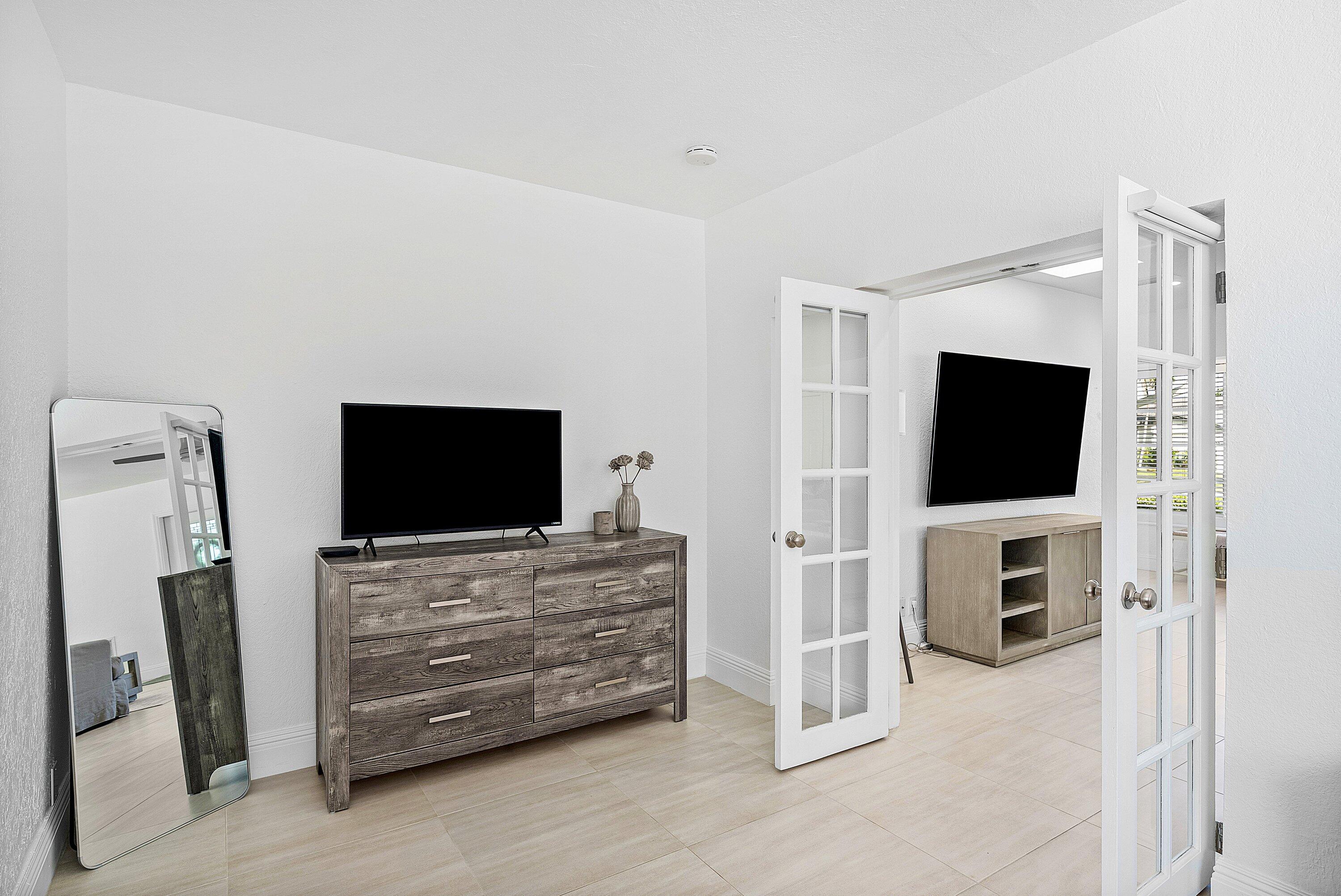 124 Oregon Lane Boca Raton, FL 33487 - Photo 16 of 41 a room with furniture and flat screen tv