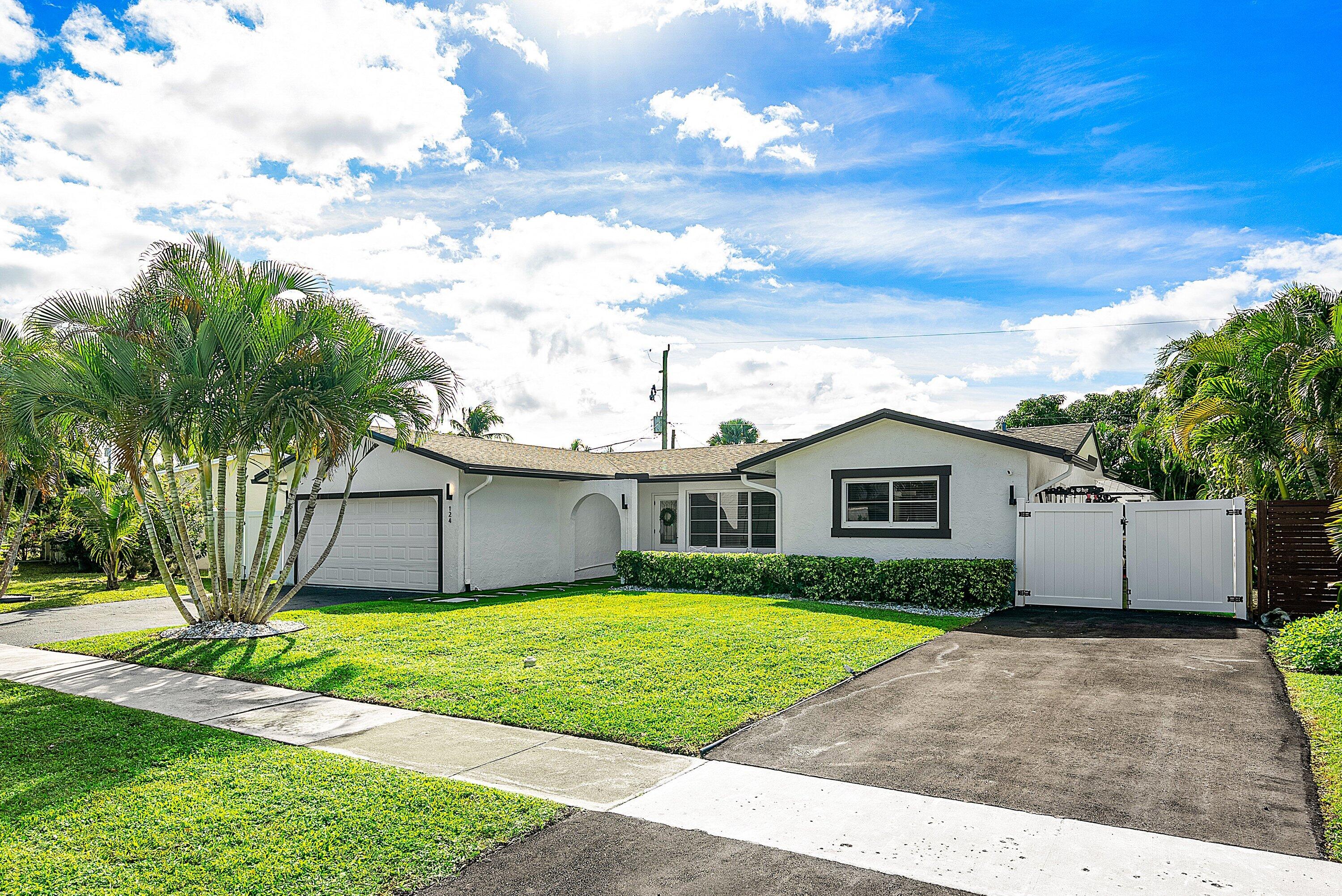 124 Oregon Lane Boca Raton, FL 33487 - Photo 2 of 41 a view of front of a house with a yard