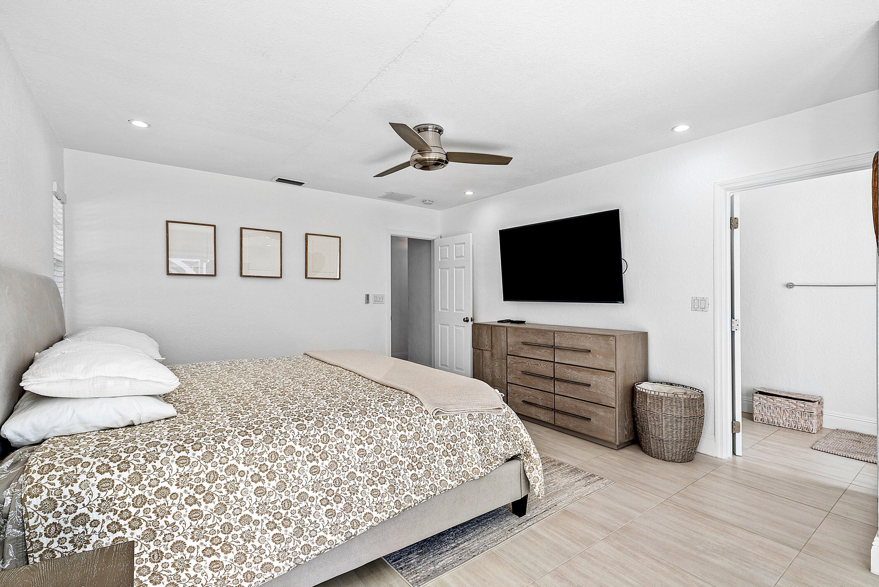 124 Oregon Lane Boca Raton, FL 33487 - Photo 22 of 41 a bedroom with a bed and a flat screen tv
