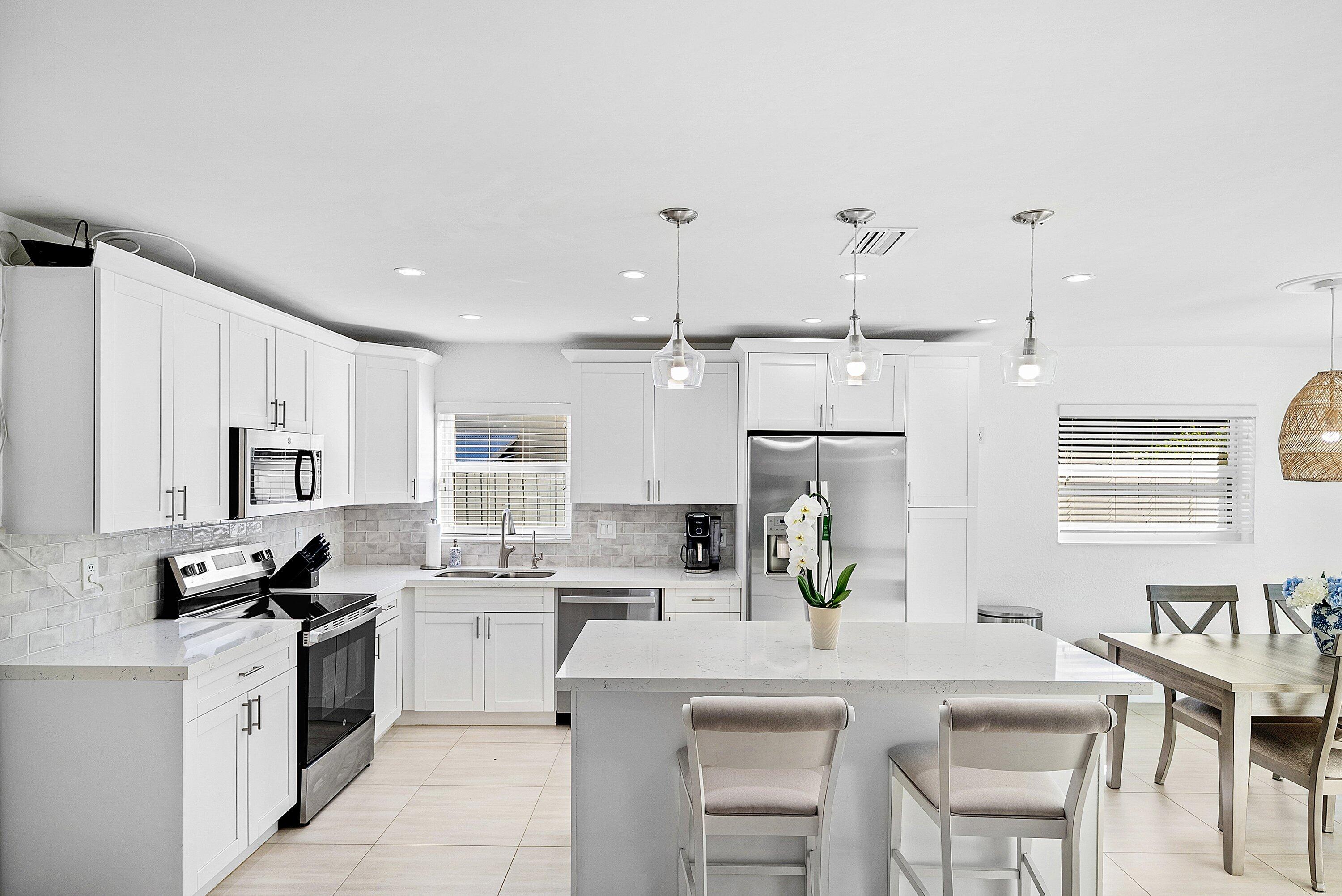 124 Oregon Lane Boca Raton, FL 33487 - Photo 6 of 41 a kitchen with cabinets a sink and appliances