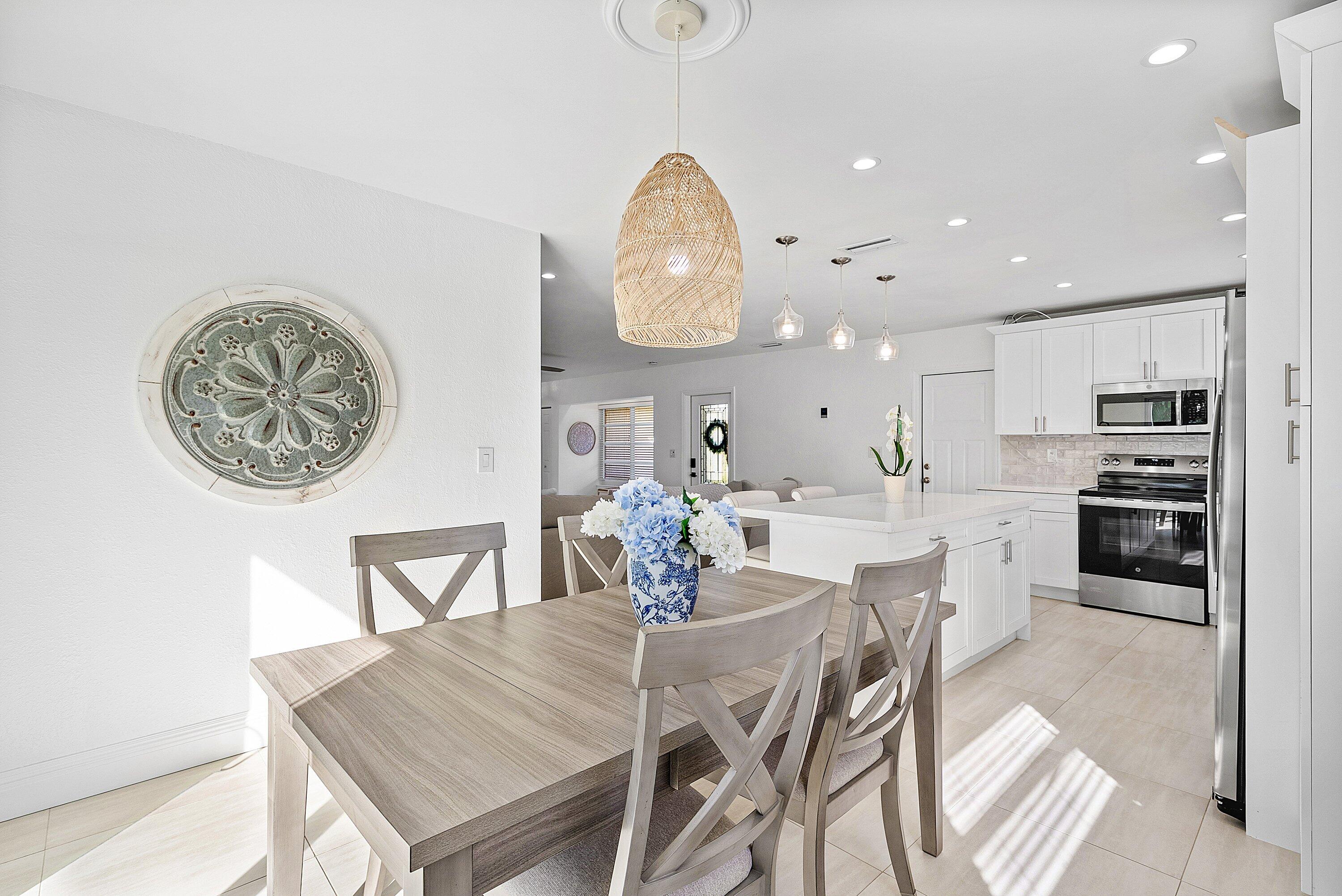 124 Oregon Lane Boca Raton, FL 33487 - Photo 8 of 41 a dining room with furniture and a kitchen view