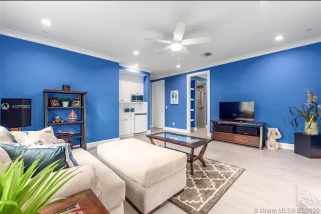 a kitchen with cabinets and a refrigerator