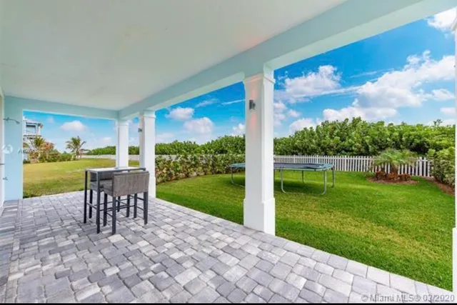 a view of a hallway with kitchen and dining room view