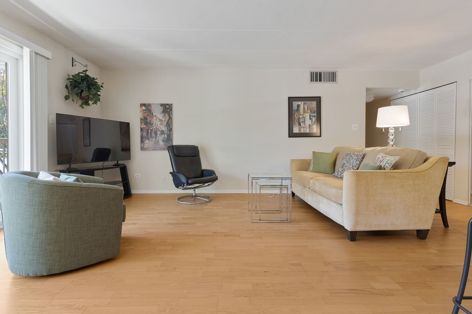6443 Clarendon Hills Road, Unit 206 Willowbrook, IL 60527 - Photo 3 of 21 a living room with furniture and a flat screen tv