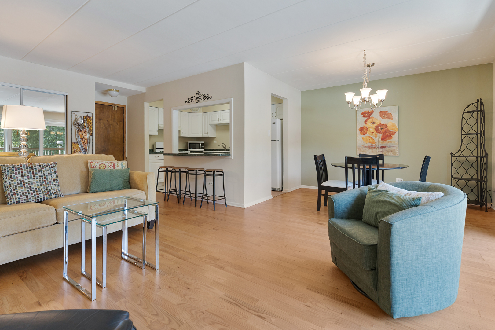 6443 Clarendon Hills Road, Unit 206 Willowbrook, IL 60527 - Photo 5 of 21 a living room with furniture and a chandelier