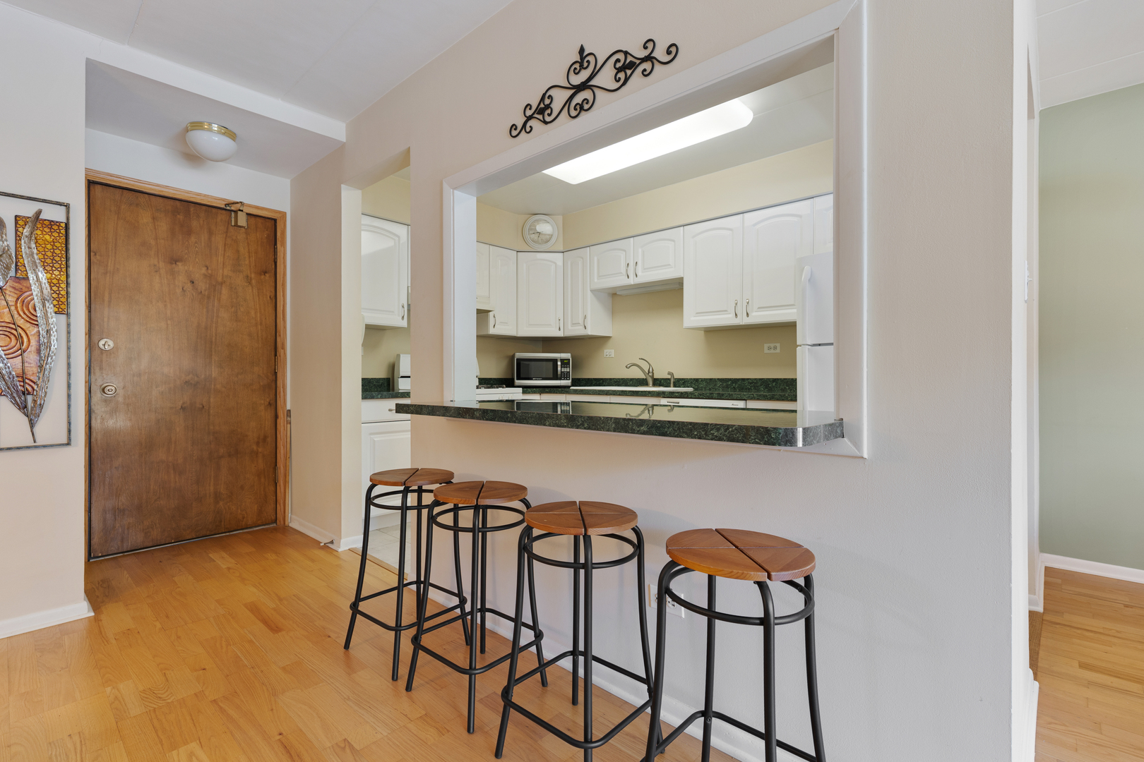 6443 Clarendon Hills Road, Unit 206 Willowbrook, IL 60527 - Photo 8 of 21 a kitchen with stainless steel appliances granite countertop a chair a stove and a refrigerator