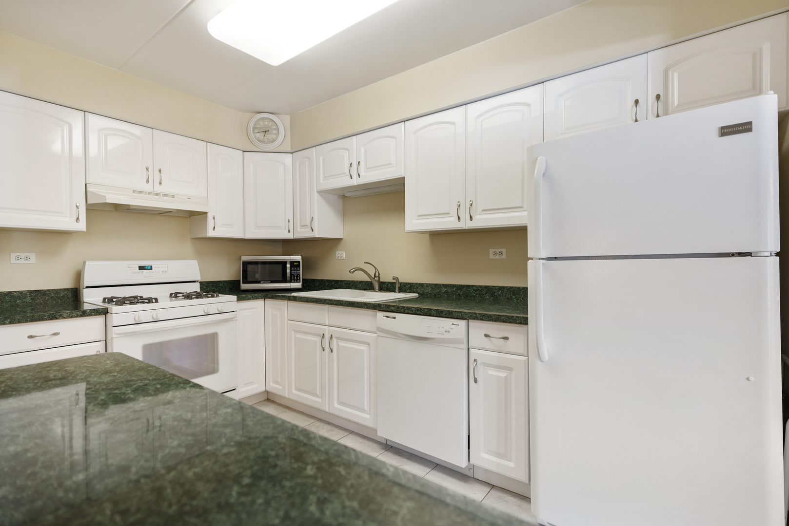 6443 Clarendon Hills Road, Unit 206 Willowbrook, IL 60527 - Photo 9 of 21 a kitchen with granite countertop white cabinets and white appliances