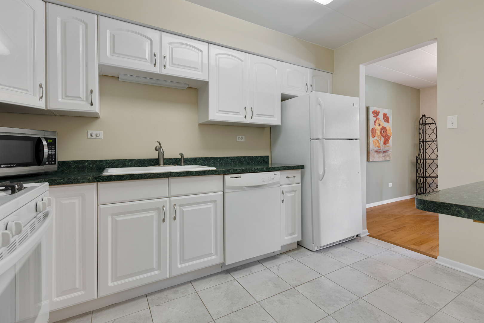 6443 Clarendon Hills Road, Unit 206 Willowbrook, IL 60527 - Photo 10 of 21 a kitchen with white cabinets and refrigerator