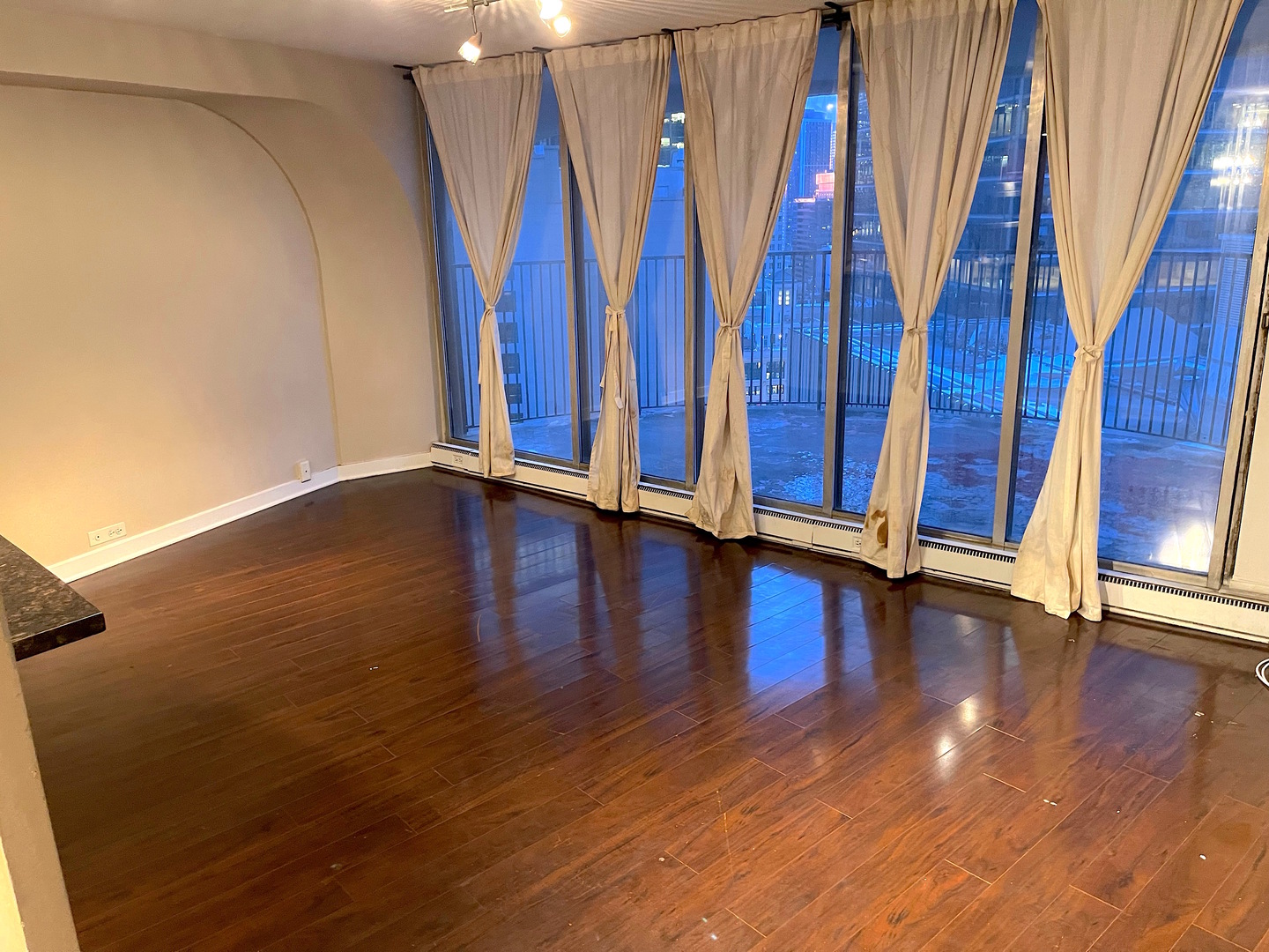 300 North State Street, Unit 2427 Chicago, IL 60654 - Photo 2 of 9 a view of an empty room with wooden floor and staircase