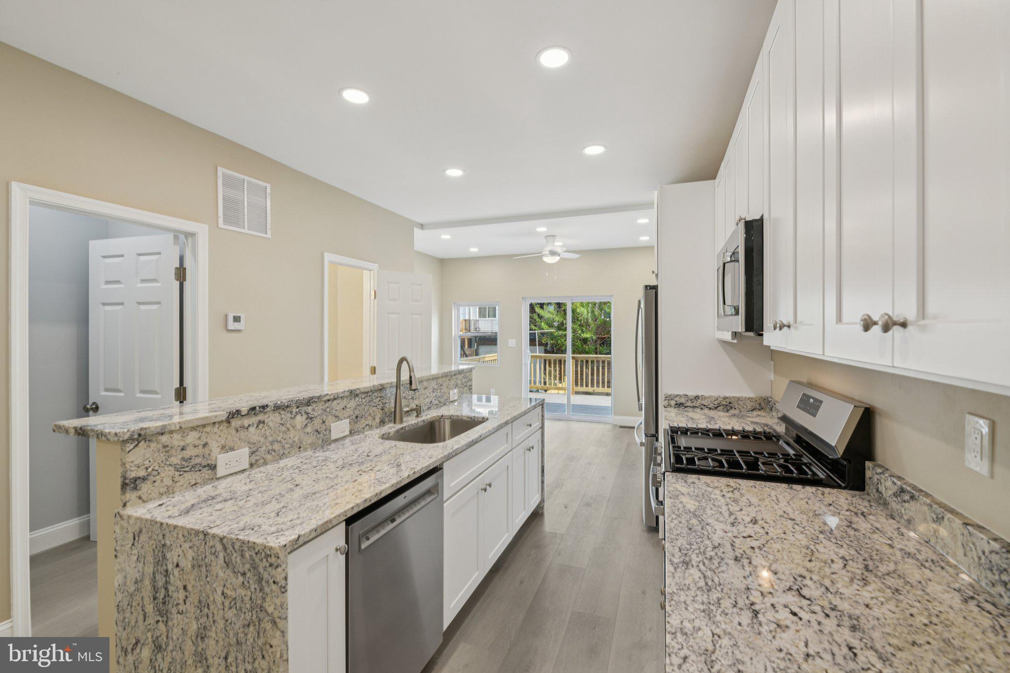 729 Madison Street Northwest Washington, DC 20011 - Photo 14 of 59 a kitchen with granite countertop a sink and a stove top oven