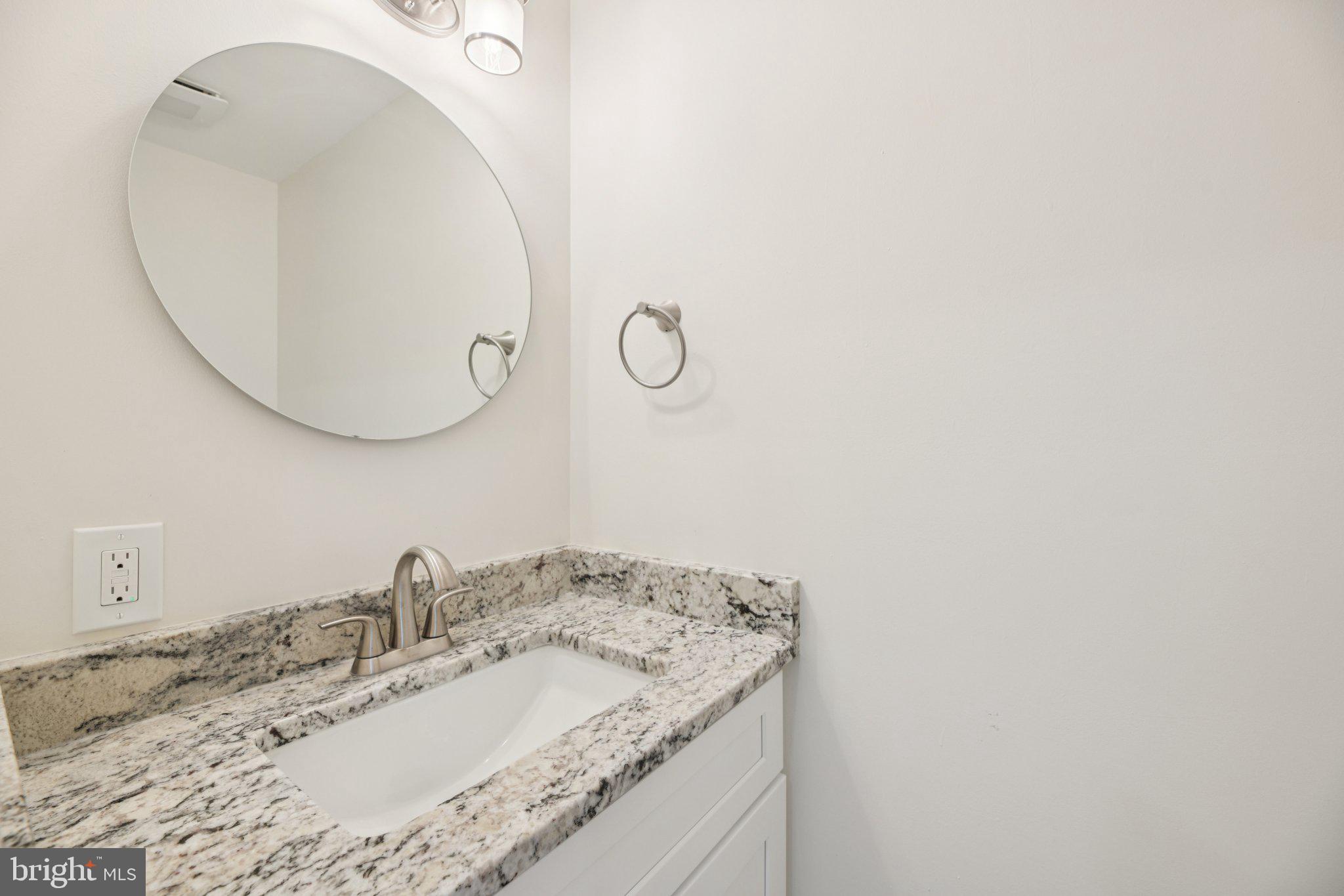 729 Madison Street Northwest Washington, DC 20011 - Photo 17 of 59 a bathroom with a granite countertop sink and a mirror