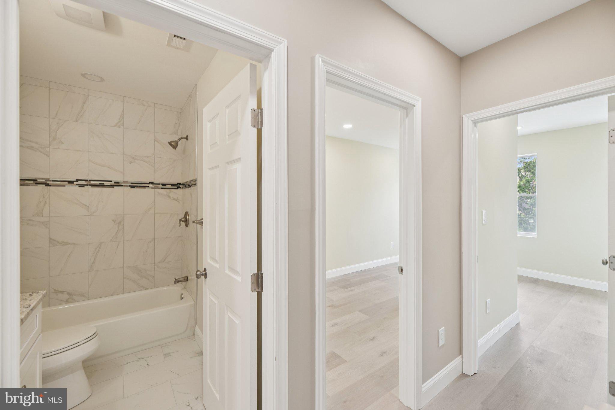 729 Madison Street Northwest Washington, DC 20011 - Photo 37 of 59 a bathroom with a glass shower door
