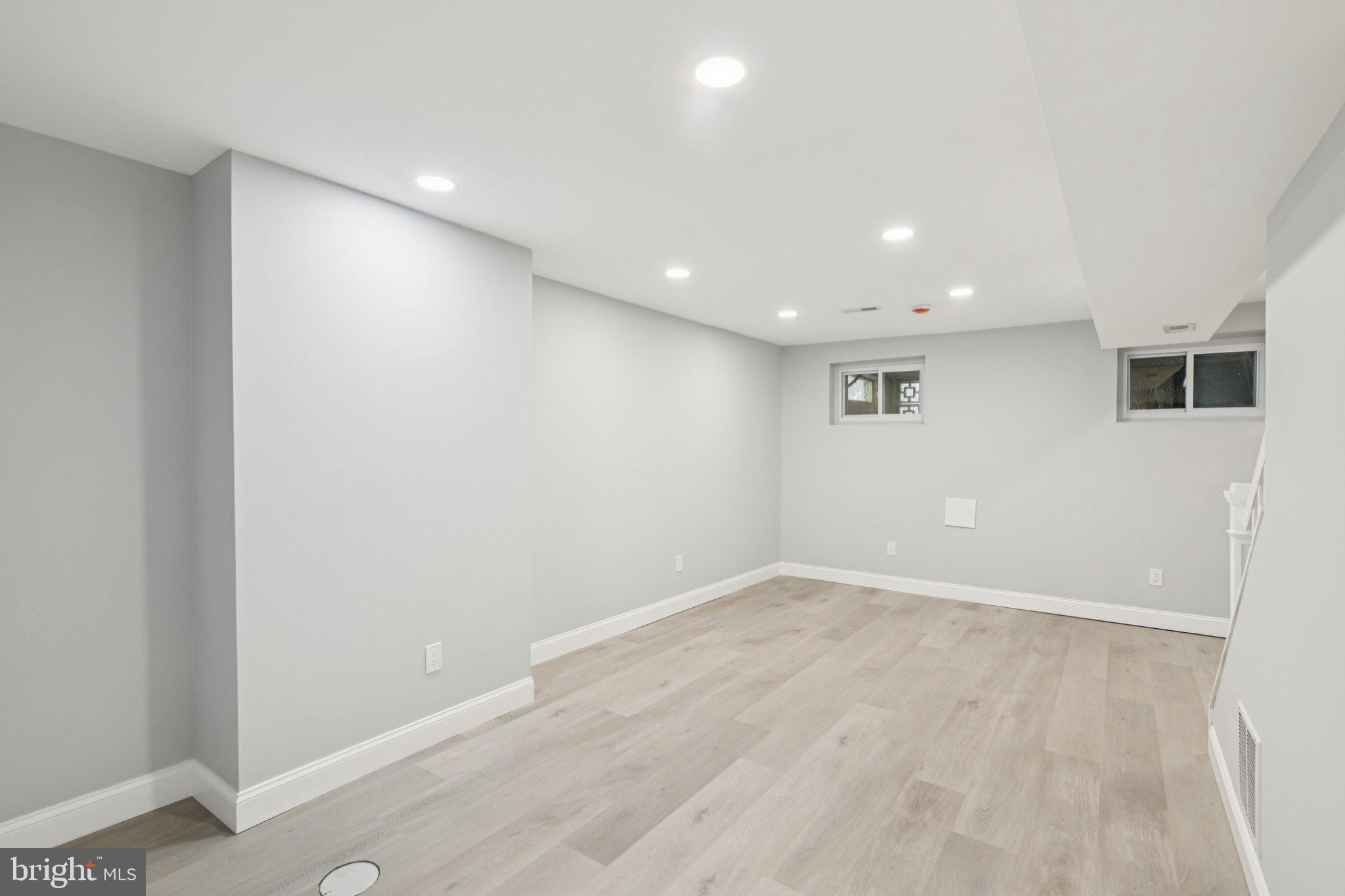 729 Madison Street Northwest Washington, DC 20011 - Photo 44 of 59 an empty room with wooden floor and windows