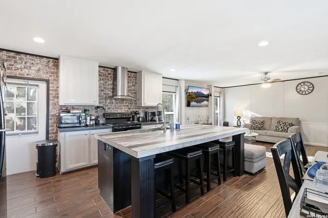 a kitchen with stainless steel appliances granite countertop a stove and a refrigerator
