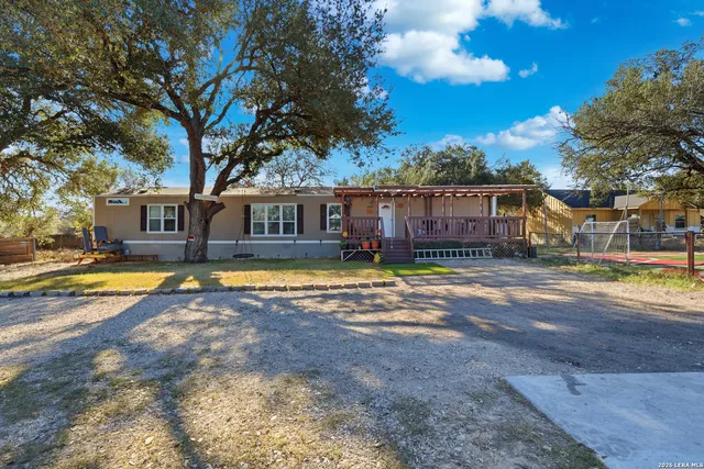 a view of a house with swimming pool and a yard