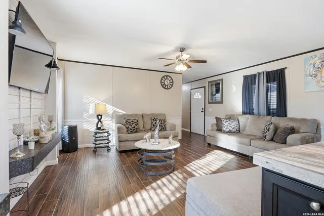 a living room with furniture and wooden floor
