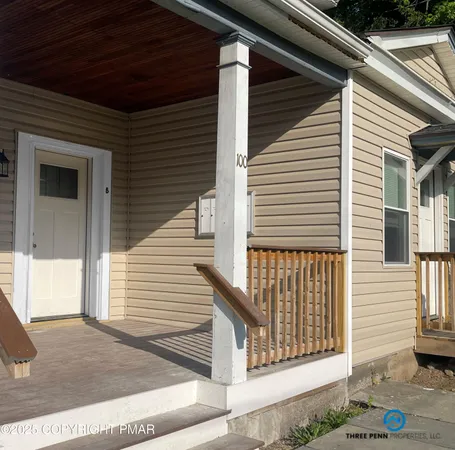 a view of a house with a door and wooden floor