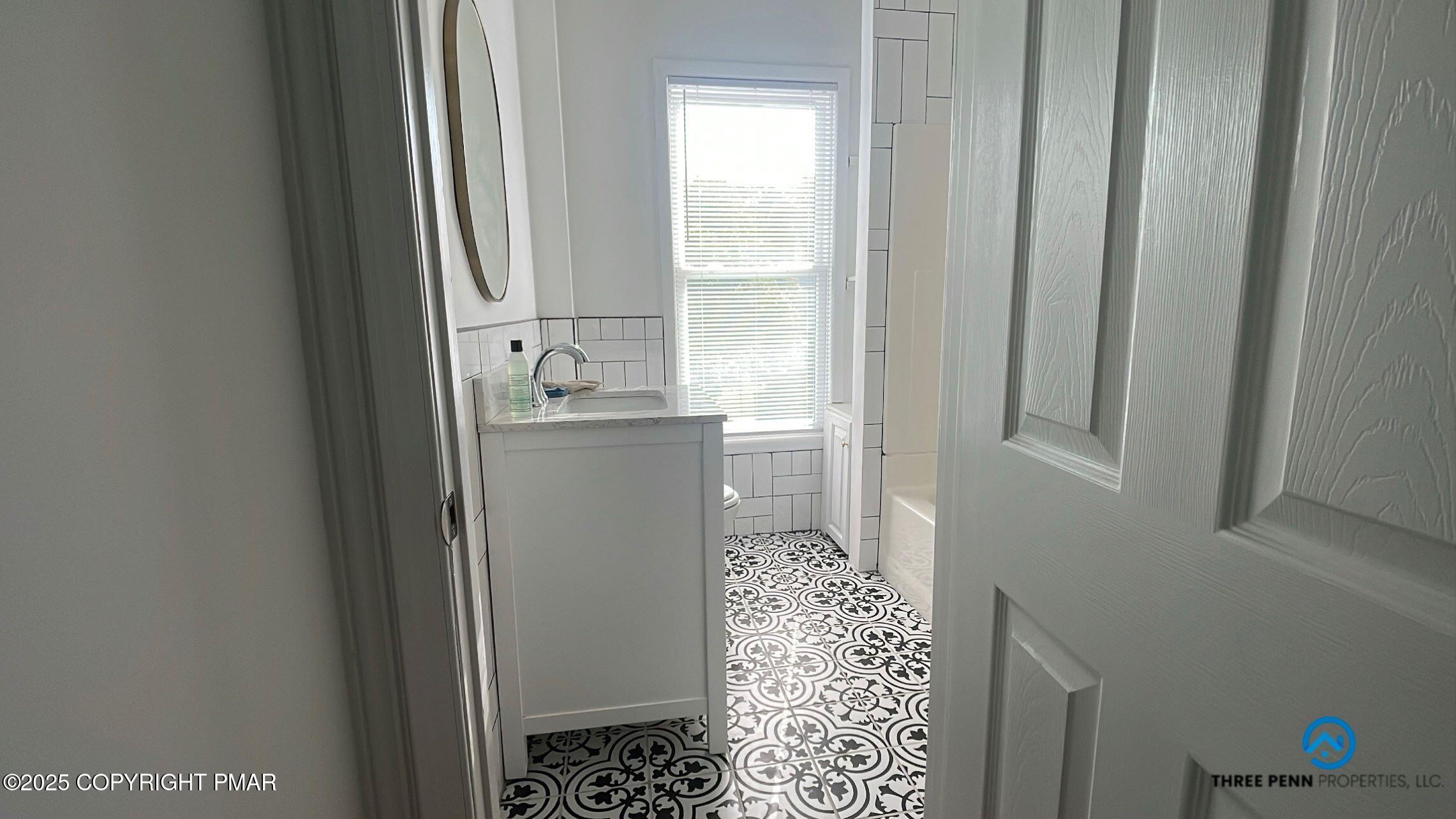 100 Broad Street, Unit B Stroudsburg, PA 18360 - Photo 11 of 18 a bathroom with a sink and a mirror