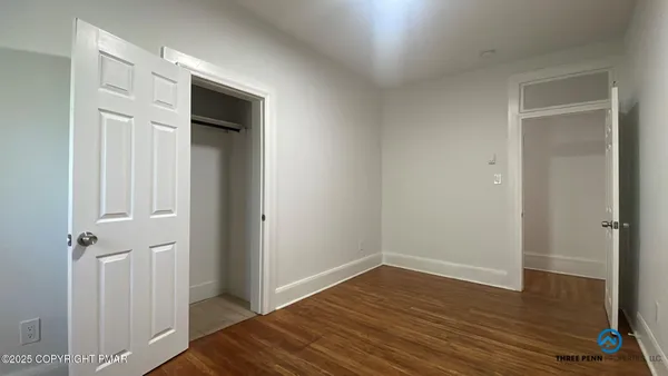 a view of a hallway with wooden floor