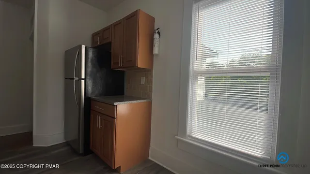 a kitchen with a refrigerator and window