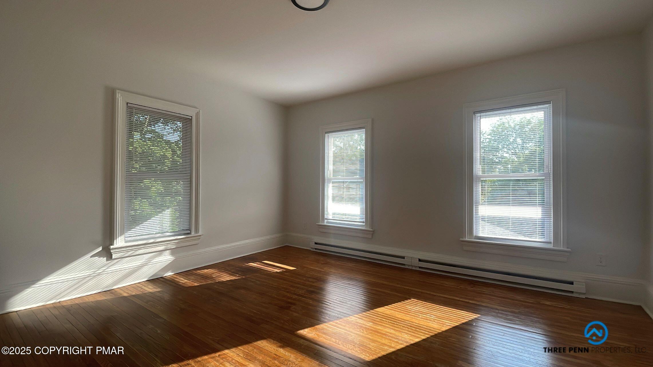 100 Broad Street, Unit B Stroudsburg, PA 18360 - Photo 4 of 18 a view of an empty room with wooden floor and a window