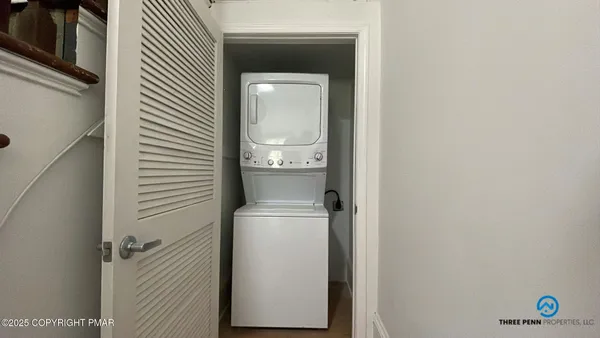 a view of a hallway with a washer and dryer