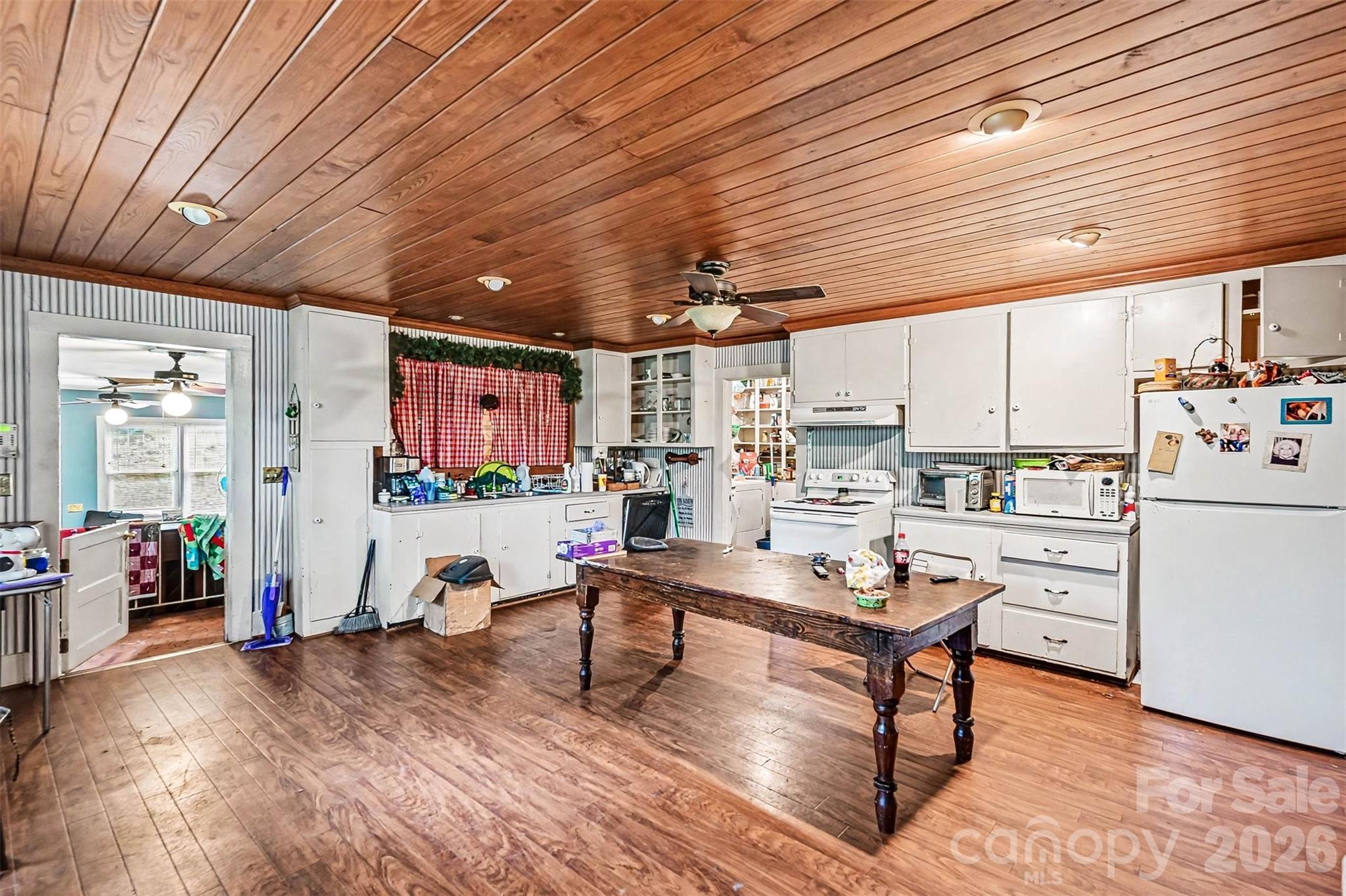 1116 Medlin Road Monroe, NC 28112 - Photo 4 of 40 a living room with kitchen furniture and a table