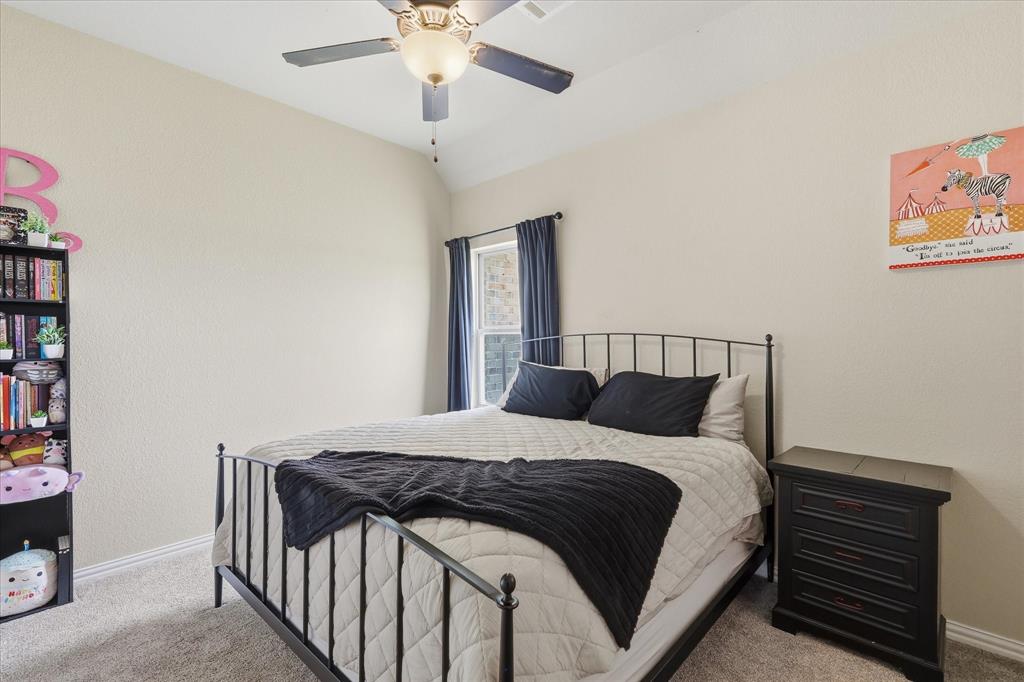 160 Vista Ridge North Decatur, TX 76234 - Photo 30 of 40 a bedroom with a bed and a chandelier