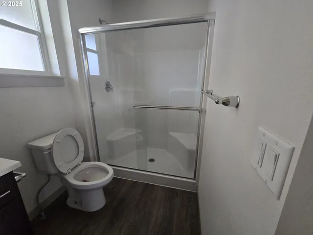 a bathroom with a toilet and a shower