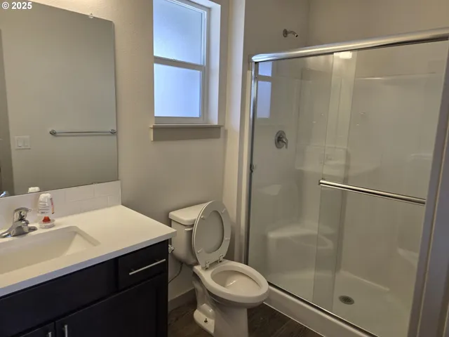 a bathroom with a sink toilet and shower