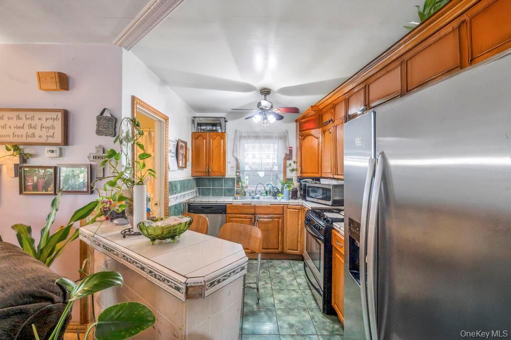182 Commack Road Deer Park, NY 11729 - Photo 13 of 24 a kitchen with stainless steel appliances granite countertop a sink and a refrigerator