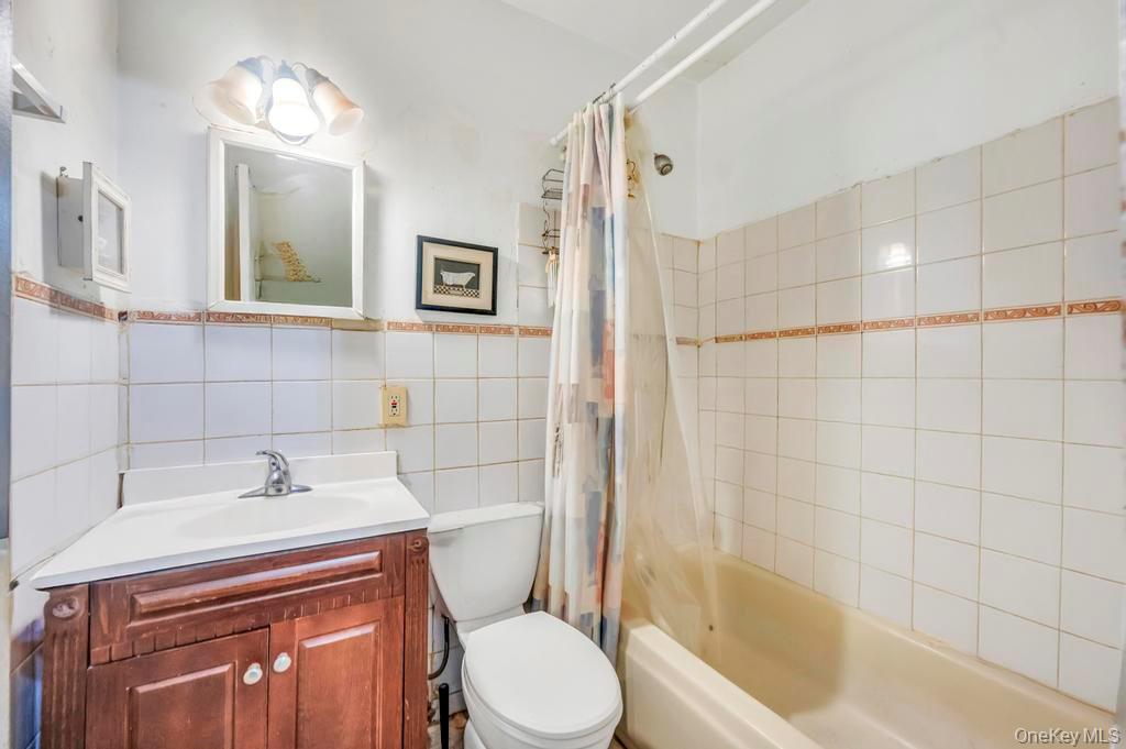 182 Commack Road Deer Park, NY 11729 - Photo 15 of 24 a bathroom with a sink toilet and shower