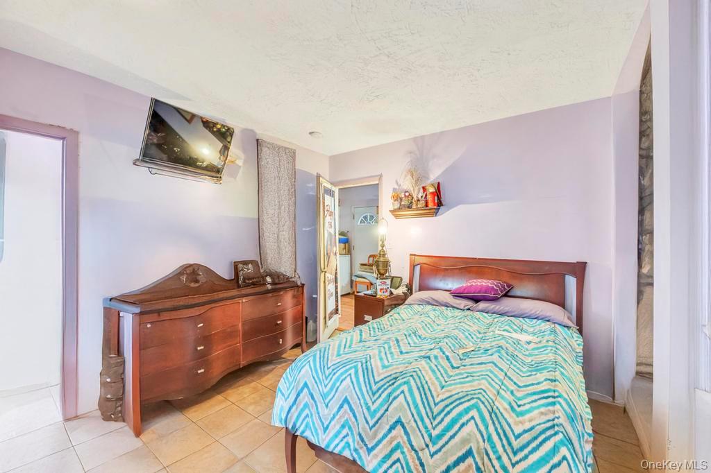 182 Commack Road Deer Park, NY 11729 - Photo 20 of 24 a bedroom with a bed and wooden floor