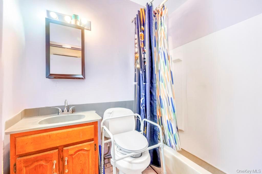 182 Commack Road Deer Park, NY 11729 - Photo 21 of 24 a bathroom with a sink and a toilet