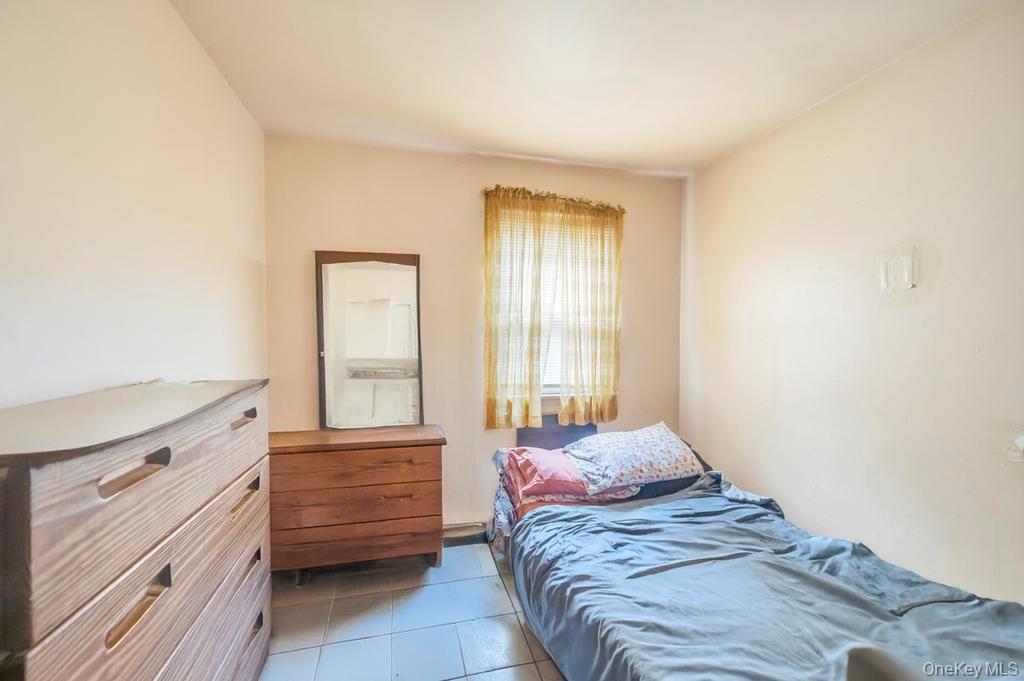 182 Commack Road Deer Park, NY 11729 - Photo 22 of 24 a bedroom with a bed and a window