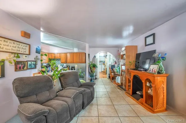 a living room with furniture a fireplace and a large window