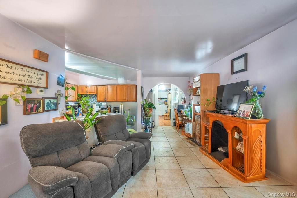 182 Commack Road Deer Park, NY 11729 - Photo 10 of 24 a living room with furniture a fireplace and a large window