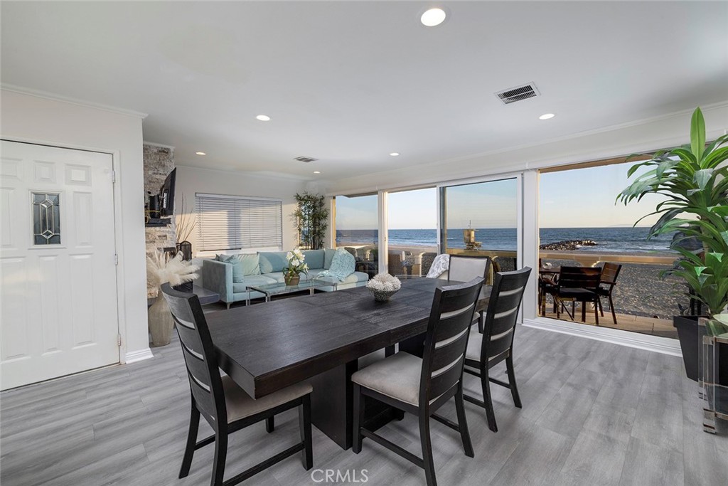 4005 Seashore Drive Newport Beach, CA 92663 - Photo 18 of 32 a view of a dining room with furniture and wooden floor