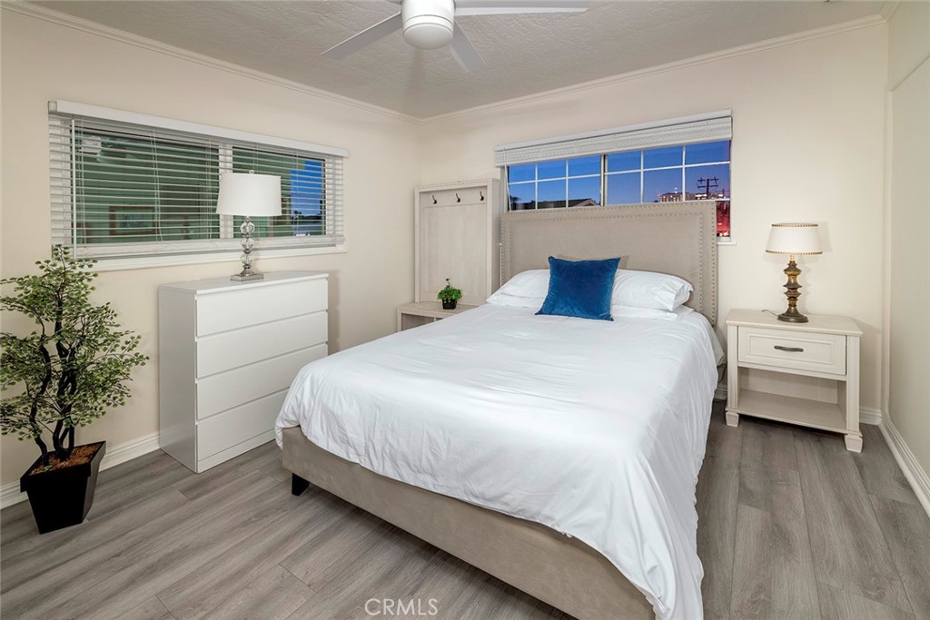 4005 Seashore Drive Newport Beach, CA 92663 - Photo 22 of 32 a bedroom with a large bed and a flat tv screen on dresser