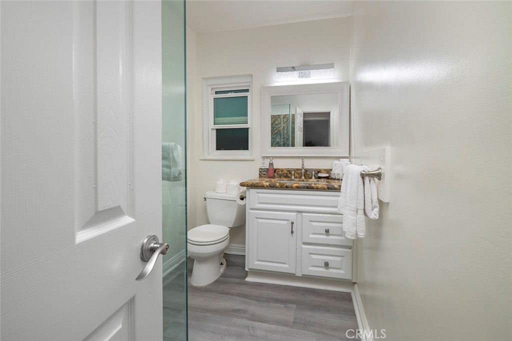 4005 Seashore Drive Newport Beach, CA 92663 - Photo 23 of 32 a bathroom with a granite countertop sink toilet and mirror