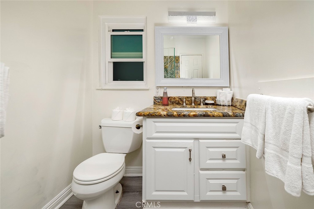 4005 Seashore Drive Newport Beach, CA 92663 - Photo 25 of 32 a bathroom with a toilet sink and mirror