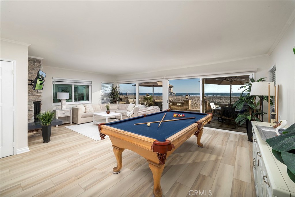 4005 Seashore Drive Newport Beach, CA 92663 - Photo 4 of 32 a living room with furniture a flat screen tv and a table
