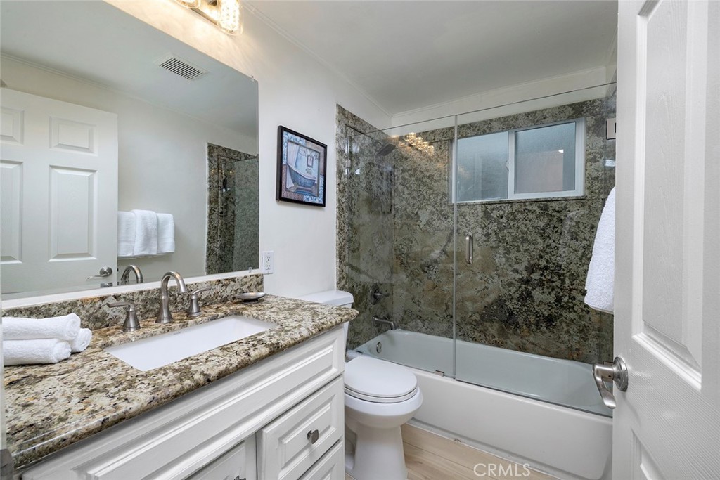4005 Seashore Drive Newport Beach, CA 92663 - Photo 9 of 32 a bathroom with a granite countertop sink toilet and shower