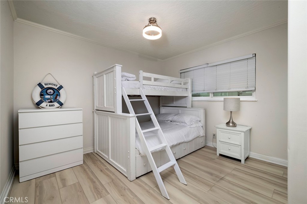 4005 Seashore Drive Newport Beach, CA 92663 - Photo 10 of 32 a bed room with a bed and white walls